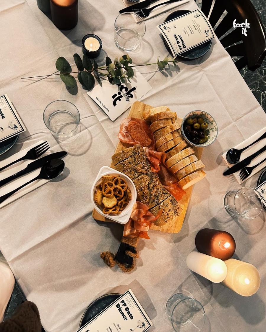 A candlelit Fork It date dinner table with a charcuterie board