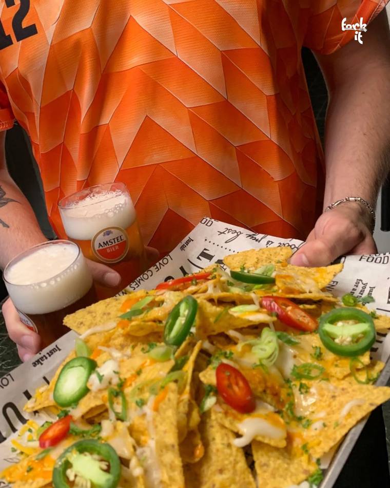 Loaded fries being served from a takeaway tray