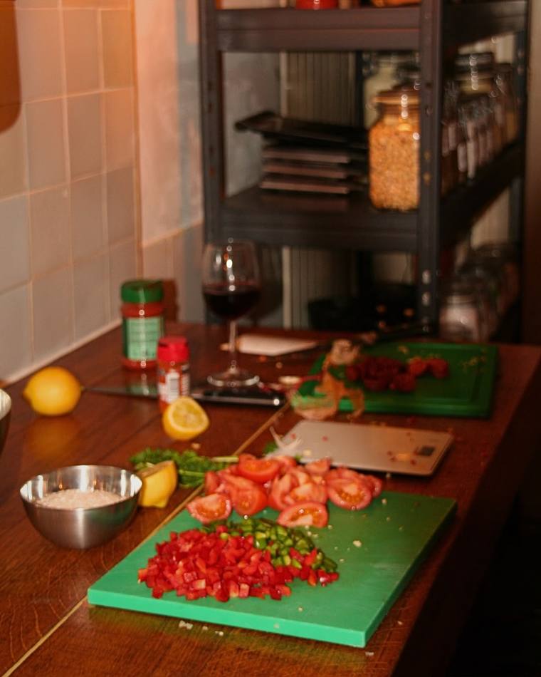 Prepped tomatoes, peppers, and herbs ready for the paella pan